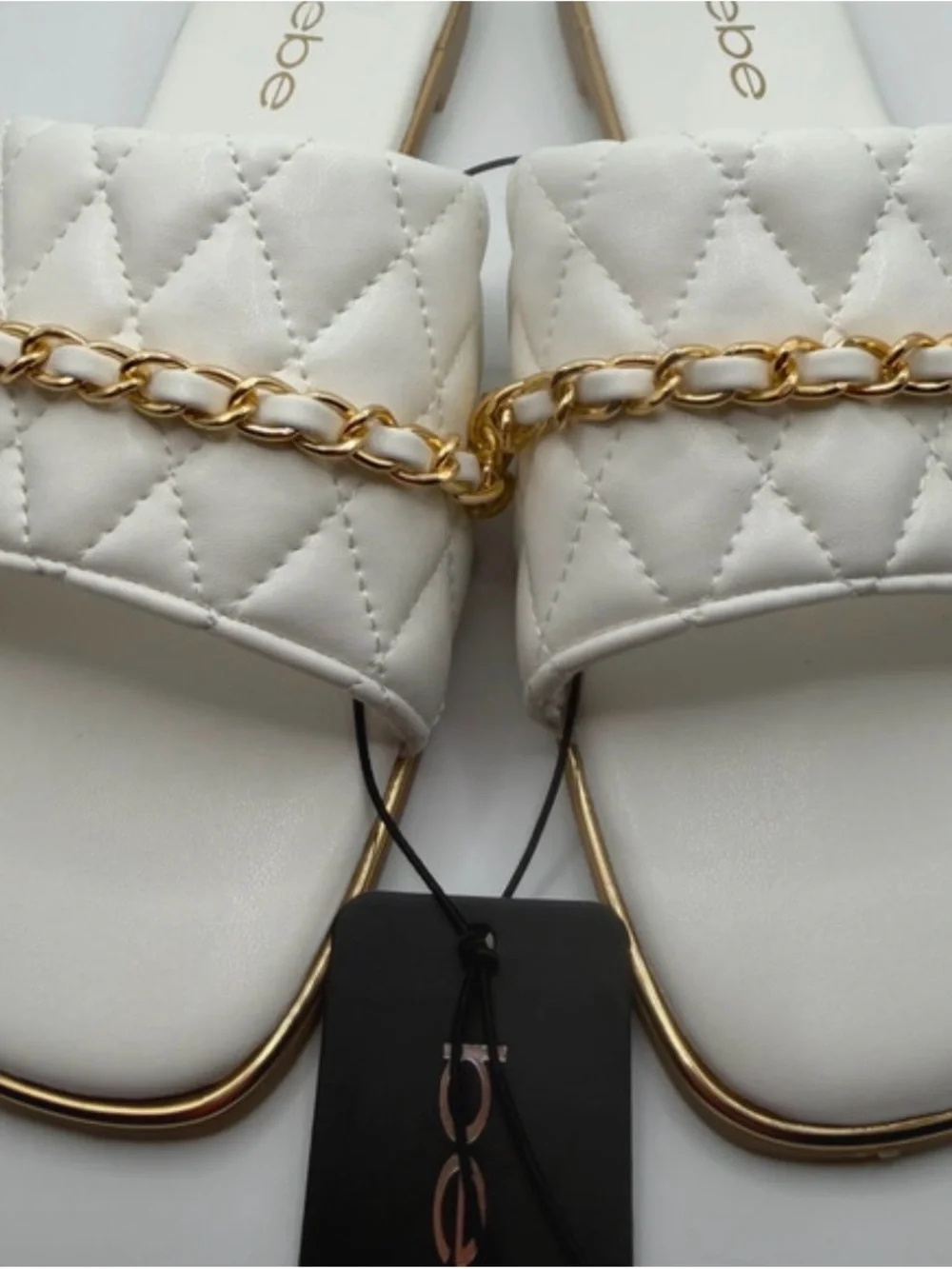 bebe White Quilted Slide Sandals with Gold Chain Accent